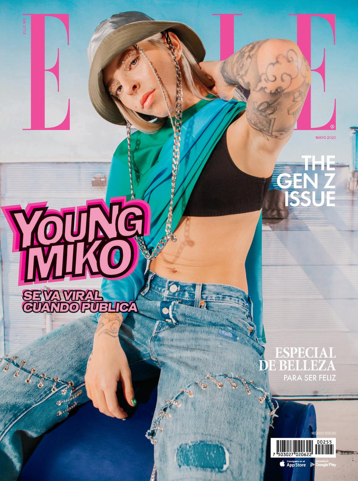 Cover of an 'Elle' Magazine from  May 2023 featuring 'Young Miko' wearing a bucket hat with a long chain instead of a chinch, temporary jewlery accenting her eye makeup, a blue-green sweater worn around one arm and a pair of torn jeans held together with a series of grommets of chains.
